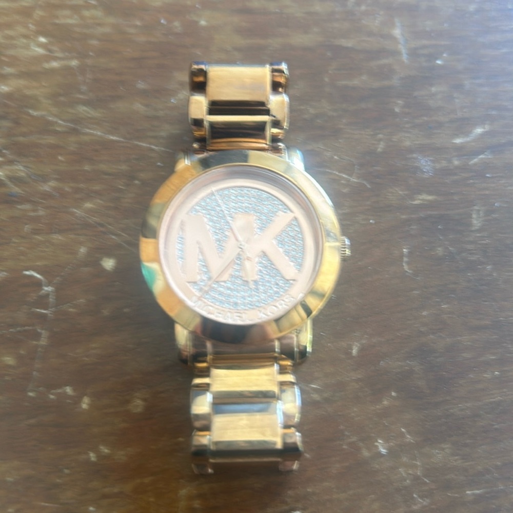 Michael Kors gold watch with complete stone face.